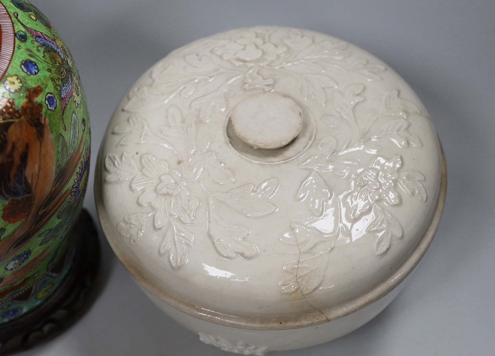 A Chinese clobbered vase and cover, and a blanc de chine bowl and cover, tallest 30cms high (2)